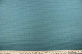 This quilted jacquard fabric in aquamarine is durable and hard wearing with a rating of 30,000 double rubs. 