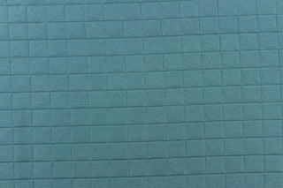This quilted jacquard fabric in aquamarine is durable and hard wearing with a rating of 30,000 double rubs. 