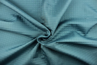 This quilted jacquard fabric in aquamarine is durable and hard wearing with a rating of 30,000 double rubs. 