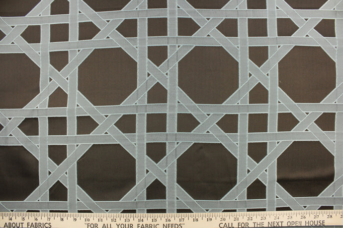 This fabric features a large geometric design in gray/blue on a brown background.  It would be great for home decor such as multi-purpose upholstery, window treatments, pillows, duvet covers, tote bags and more.  It has a soft workable feel yet is stable and durable.
