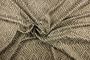 This fabric features a geometric print in the colors of gold, brown with hints of blue.   It has a soft drapable hand and would be ideal for swags, window scarves and drapery panels.