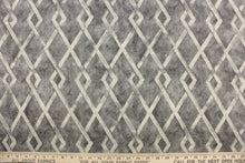 Load image into Gallery viewer, This fabric features a geometric design in gray tones. 
