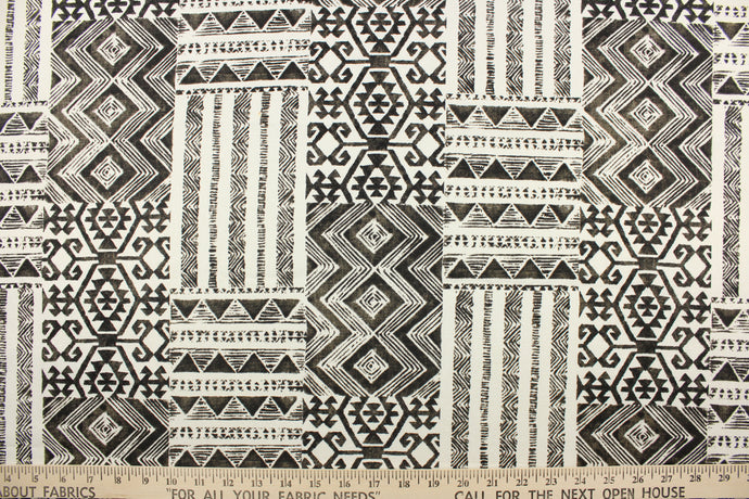 This fabric features a geometric Aztec design in black and white. 