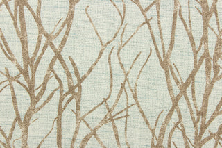 This fabric features a branch design in brown against a blue.