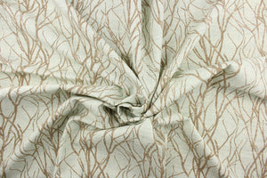 This fabric features a branch design in brown against a blue.