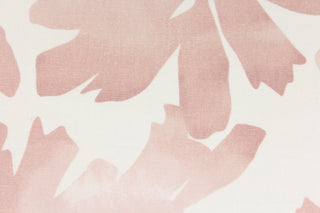 This fabric features a floral design in a pale pink against a white background. 