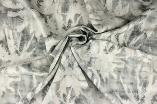 This fabric features a silhouette palm tree design in a dull white and shades of gray.