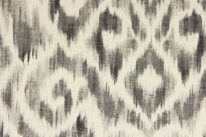 This fabric features a Ikat design in varying shades of gray and dull white.