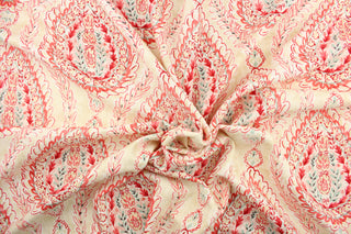 This fabric features a demask design in varying shades of pink, red, turquoise, and dark gray against a off white.