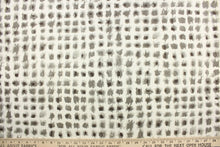 Load image into Gallery viewer, This fabric features a geometric design of small blots in gray against a white background.
