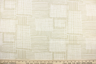This fabric features a geometric design in a light beige and white.