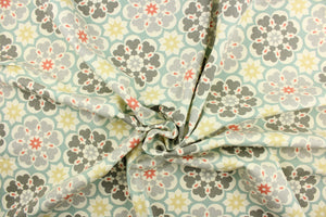 This fabric features a floral medallion design in shades of gray, golden beige, coral, turquoise, and dull white. 