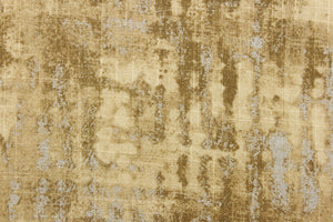 This fabric features an abstract design in brown tones, tan, and light beige with hints of sliver.