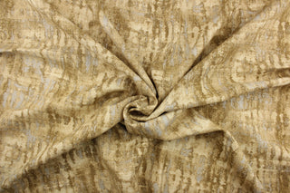 This fabric features an abstract design in brown tones, tan, and light beige with hints of sliver.