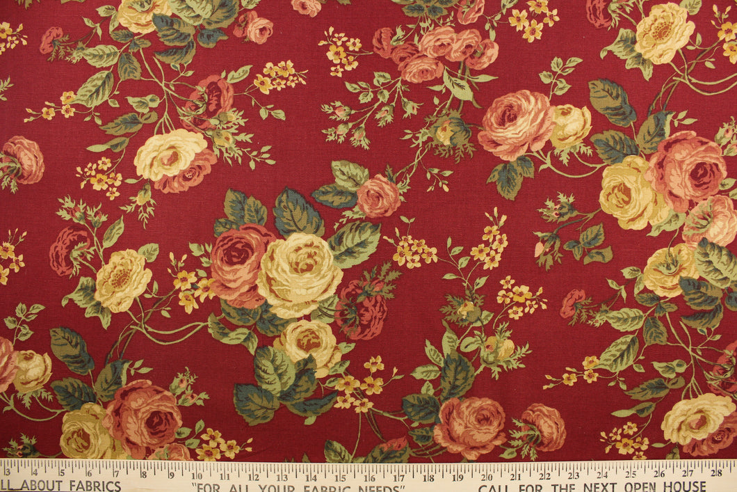 This fabric features a floral design in rose pink, burgundy, green, golden tan, beige, and hunter green against a deep red. 