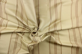  This light weight  fabric offers a formal feel. Featuring a  vertical striped pattern  in beige and dull gold colors of  with a  slight sheen to enhance the rich colors and overall design. 