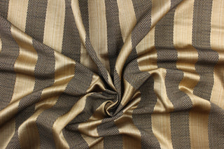  This stunning yarn dyed fabric features a  wide striped pattern in black and gold . Enhancing the various colors of the stripes is a slight sheen.