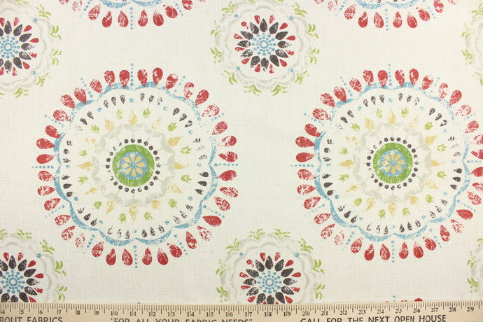 This fabric features a decorative circular design in a light gray, golden beige, spring green, dark brown, deep coral red, and gray blue against a dull white.