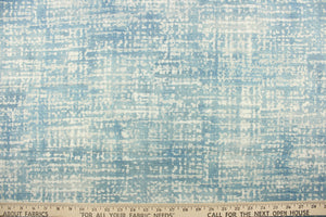  This fabric abstract design in blue, dull white and hints of gray. It has a distressed look about it enhancing the design.