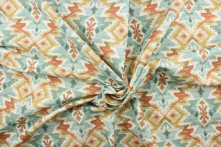 This fabric features an Aztec design in deep orange, golden beige, turquoise, white, gray, and pale peach. 