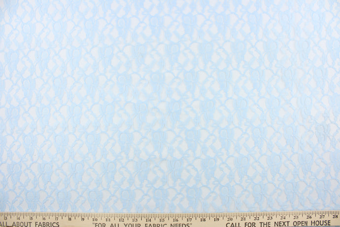 This lace features a woven floral design in a light blue.