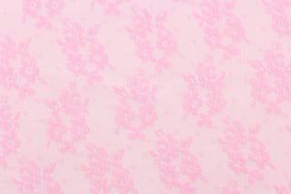 This lace features a small woven floral design in pink.