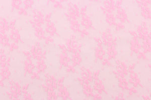 This lace features a small woven floral design in pink.