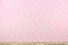 Load image into Gallery viewer, This lace features a woven floral design in pink. 
