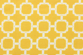 This outdoor fabric features a geometric design in white against a yellow background. 