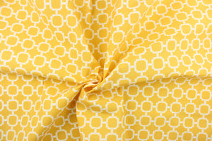 This outdoor fabric features a geometric design in white against a yellow background. 