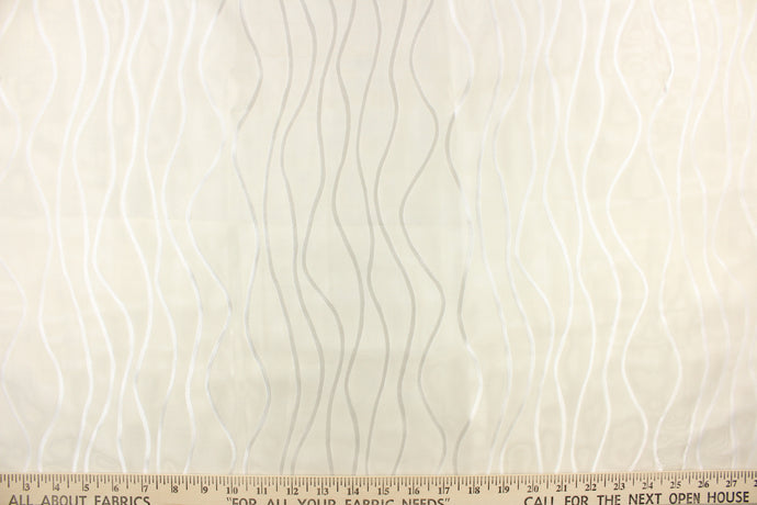 This sheer fabric features wavy line design in white .
