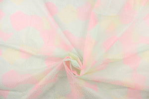 This tulle features a sparkly design in  pink, pale purple and pale turquoise. 