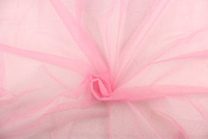 This tulle features a sparkly design in gold against a pink background.