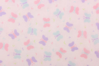 This tulle features a butterfly design in purple, blue, green and pink .