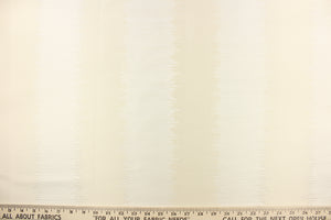 This sheer fabric features a wide stripe design in a creamy white. 