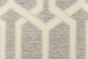 This jacquard fabric features a geometric design in gray, and white . 