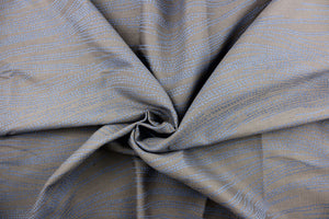 This jacquard fabric features a line design in blue against a dark taupe background.
