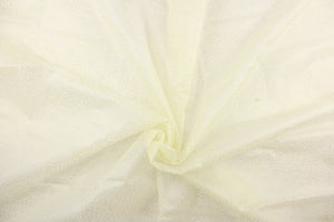  This tulle features a sparkly design in iridescent against a cream background .
