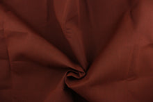 Load image into Gallery viewer,  A solid rich brown fabric great for umbrellas, outdoor upholstery and more. It has a water repellent finish, UV protection, it is fade resistant, mold and mildew resistant and abrasion resistant. 
