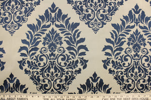 This jacquard fabric features a demask design in navy blue and beige .