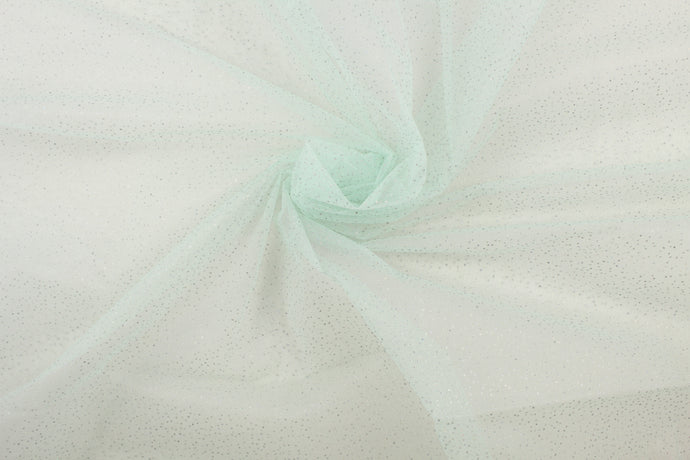 A sheer, semi firm, sparkly tulle in mint green. 