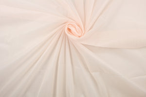 A sheer, light weight, and semi firm tricot in pale peach.