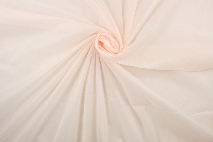 A sheer, light weight, and semi firm tricot in pale peach.