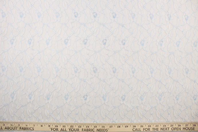 This lace features a woven floral design in baby blue and white .
