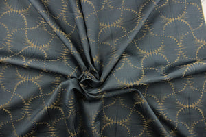 This jacquard fabric features a whimsical print in dark beige on a slate background.  It is great for home decor such as multi-purpose upholstery, window treatments, pillows, duvet covers, tote bags and more.  It has a soft workable feel yet is stable and durable with a rating of 15,000 double rubs. 