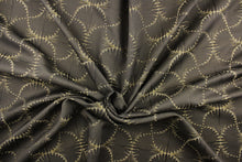 Load image into Gallery viewer, This jacquard fabric features a whimsical print in light gold on a brown background.  It is great for home decor such as multi-purpose upholstery, window treatments, pillows, duvet covers, tote bags and more.  It has a soft workable feel yet is stable and durable with a rating of 15,000 double rubs. 
