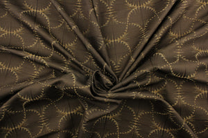 This jacquard fabric features a whimsical print in dark beige on a brown background.  It is great for home decor such as multi-purpose upholstery, window treatments, pillows, duvet covers, tote bags and more.  It has a soft workable feel yet is stable and durable with a rating of 15,000 double rubs. 