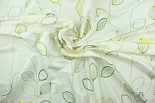 Load image into Gallery viewer, This fabric has an embossed design featuring a yellow bird perched upon green branches on an ivory background.  The slight sheen enhances the design.  Uses include light upholstery, pillows, bedding and window treatments.  
