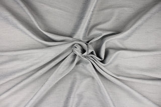 This multi-purpose mock linen in sterling silver with gray tones has a classic raw silk look and is suitable for draperies, curtains, cornice boards and headboards.  We offer this fabric in other colors.