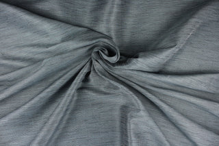 This multi-purpose mock linen in charcoal with blue tones has a classic raw silk look is suitable for draperies, curtains, cornice boards and headboards.  We offer this fabric in other colors.